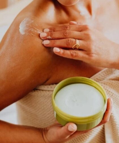 mujer con crema en el hombro